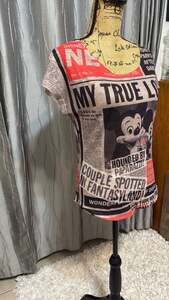 Disney Parks Authentic OriginalT-Shirt featuring a fun newspaper print